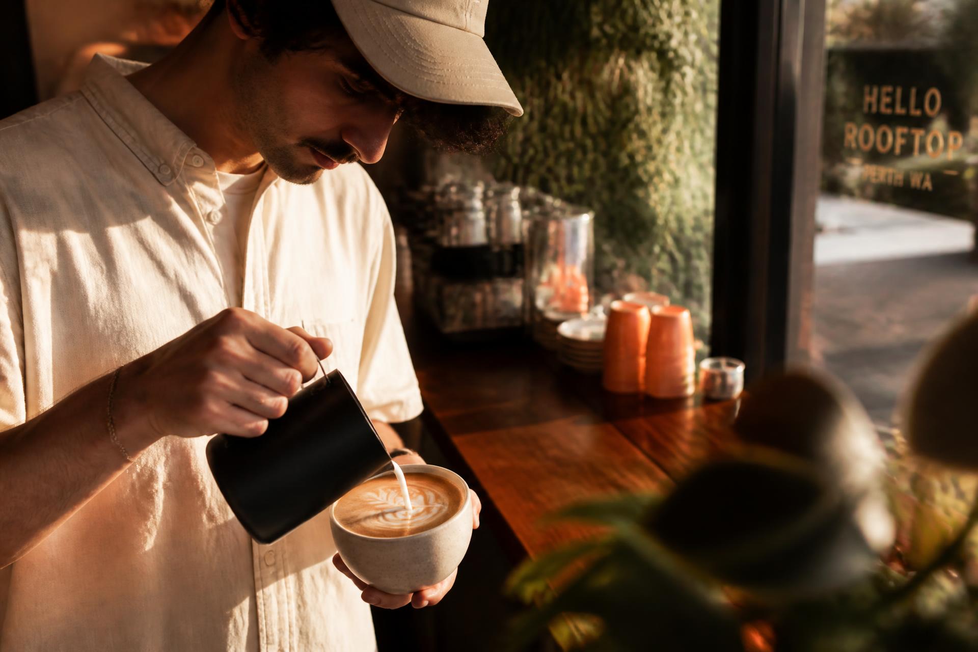 Barista pouring milk into a flat white at Lume Coffee Co, Perth